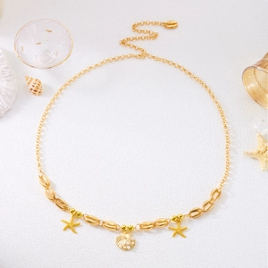 Detail of gold beach waist chain featuring starfish pendants and pearl shell charms