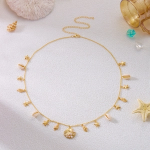 Detail of golden beach waist chain featuring starfish, shells and white pearl pendants