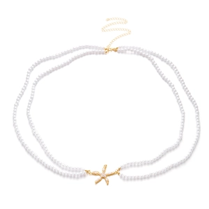 Detail of double-layer pearl waist chain with golden starfish pendant and lobster clasp