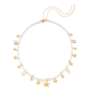 Detail of double-layer beaded waist chain with gold starfish and seashell pendants