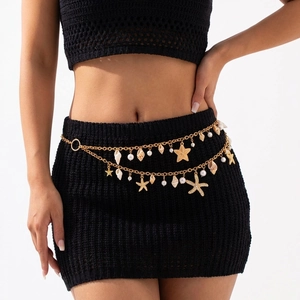 Bohemian gold layered waist chain with starfish, shells, and pearls on a model