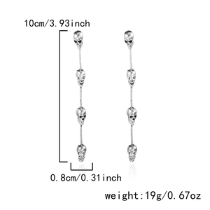 Detailed view of silver skull tassel earrings showing a length of 10cm and 19g weight