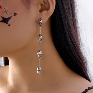 Silver skull tassel drop earrings shown on model for gothic and halloween style