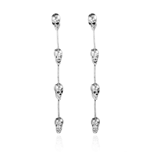 Macro view of long punk silver skull tassel earrings with fine chain vertical detail