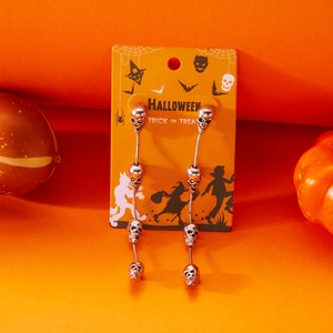 Detailed close-up of long silver skeleton tassel earrings on a Halloween gift card