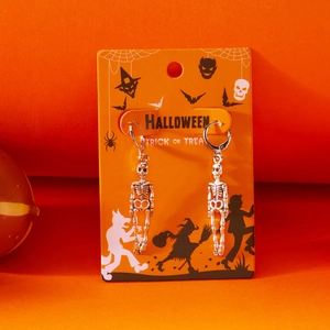 Gothic silver skull drop earrings with skeleton fringe on Halloween display card