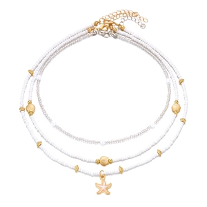 Detailed view of layered bohemian beaded necklace set with starfish and shell charms