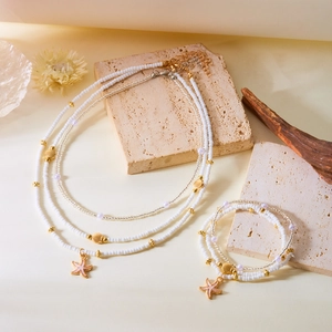 Bohemian multilayer bead necklace and bracelet set with starfish and seashell charms