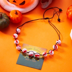 Detail of adjustable Halloween necklace with blood-splatter pattern beads and orange decor