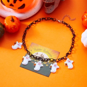 Close-up of Halloween necklace featuring white ghosts with pumpkin lanterns on black chain