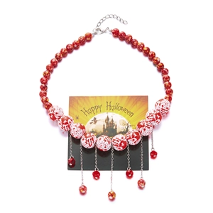 Detail of Halloween necklace with blood-splatter beads and pumpkin ghost pendant theme