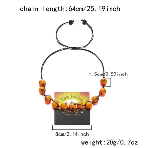 Detail view of Halloween necklace with orange spider web beads and pumpkin card dimensions