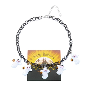 Detail of Halloween choker with five ghost charms and orange pumpkin accents on a black chain