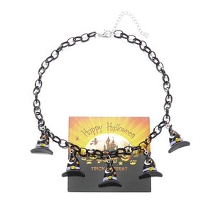 Detailed view of Halloween necklace with witch hat pendants on themed display card