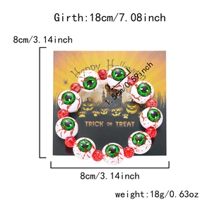 Detalle de cuentas de ojos de Halloween y cuentas rojas en pulsera elástica de 18cm