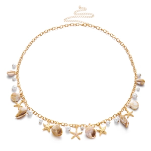 Detail of bohemian gold waist chain with natural shells, starfish charms and pearls
