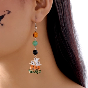 Detail of Halloween drop earrings with ghost pumpkin motifs and Wicked text charm