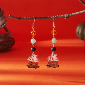 Detailed view of Halloween ghost pumpkin earrings with beads and Wicked pendant