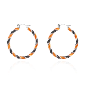 Halloween glitter pumpkin-colored spiral hoop earrings with silver clasps on white background