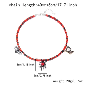 Detail of Halloween beaded necklace with bat, spider web and reaper charms