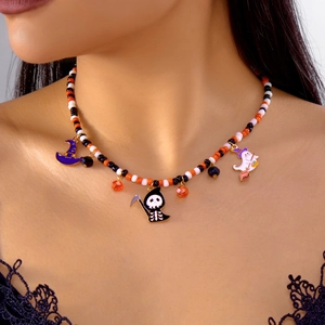 Detail of Halloween beaded necklace featuring pumpkin colors and spooky charm pendants