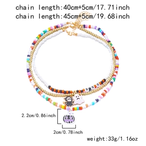 Detailed view of Halloween beaded necklaces with ghost pumpkin pendants and BOO letters