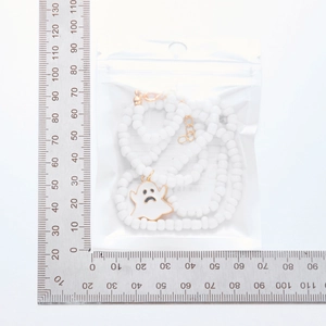 Detailed view of beaded ghost necklace with gold clasp and 22mm pendant charm