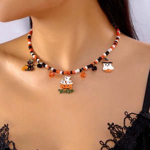 Close-up of Halloween beaded necklace with pumpkin, ghost, and cat charms on a model