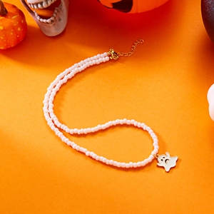 Detailed view of Halloween white beaded necklace with ghost pendant on orange background