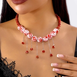 Halloween necklace with red blood splatter beads and hanging silver tassel chains