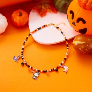 Macro shot of Halloween beaded necklace with ghost, skull and witch hat charms