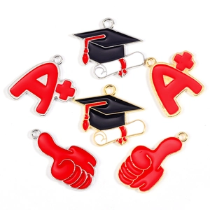 Detailed enamel graduation charms featuring black caps, A+ marks and thumbs up pendants