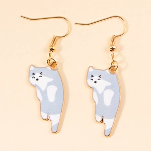 Detail of cute grey and white enamel cat earrings with gold-plated hanging hooks