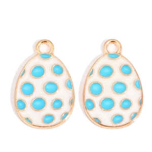 Detailed view of egg-shaped enamel pendants with blue polka dots for DIY jewelry making