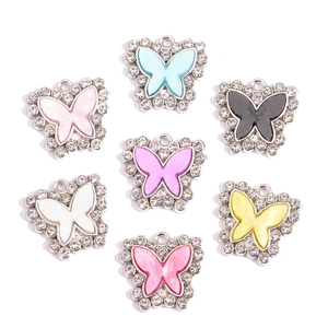 Set of seven colorful butterfly pendants with alloy base and sparkling rhinestones