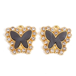 Detail showing a pair of black enamel butterfly charms with sparkling white rhinestones