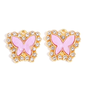 Detailed view of butterfly charms with purple enamel and clear rhinestones for DIY jewelry