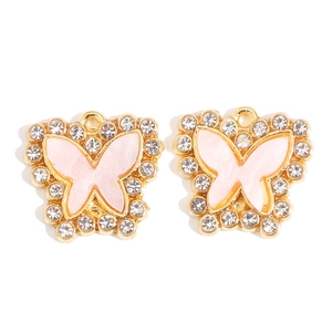 Detailed view of pink butterfly alloy pendant with sparkling rhinestones and gold plating