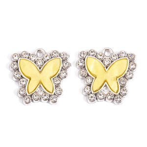 Detail of silver alloy butterfly pendants with yellow enamel and sparkling rhinestones