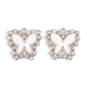 Close-up of silver-tone alloy butterfly pendants with white enamel and sparkling rhinestones