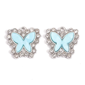 Detailed view of light blue acrylic butterfly charms with sparkling crystal rhinestones