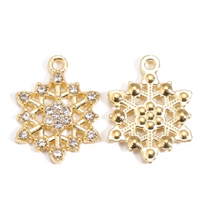 Macro detail of snowflake pendant with crystal rhinestones and golden metal backing