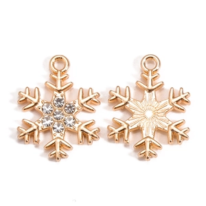Detail of gold snowflake pendant with sparkling rhinestones and metal texture back