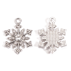 Detailed front and back view of silver snowflake pendants with rhinestone accents for DIY jewelry