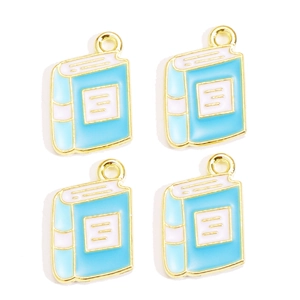 Close-up of four light blue book-shaped alloy pendants with gold-plated edges for DIY