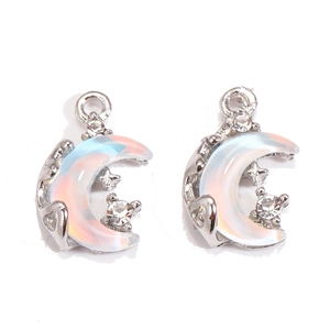 Macro view of iridescent moon charm with stars and cubic zirconia for DIY jewelry