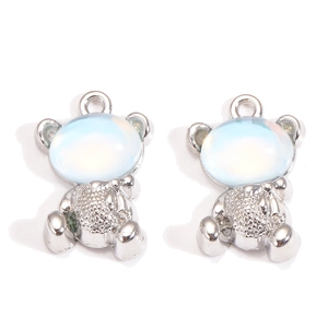 Macro shot of silver bear pendants with light blue opal stones for DIY jewelry