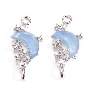Detail view of light blue moon pendants with silver alloy stars and zircons for DIY jewelry