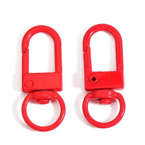 Close-up of dual red metal lobster clasps with rotating rings for DIY accessory making