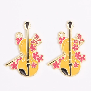 Detail of yellow enamel violin charms with pink flower and butterfly for DIY jewelry